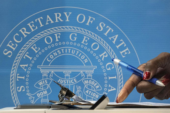 A voter fills out paperwork before casting her ballot in Atlanta during early voting for the U.S. Senate runoffs in Georgia.