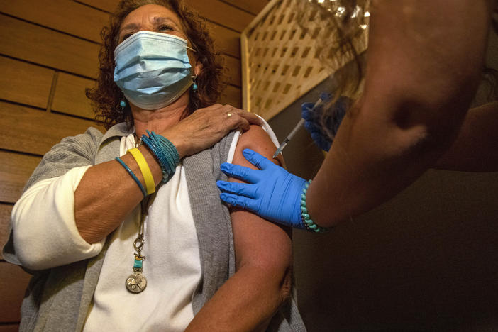 Edna Halup, a staff member at a private nursing home, receives a Pfizer COVID-19 vaccine, in Ganei Tikva, Israel, on Dec. 22.