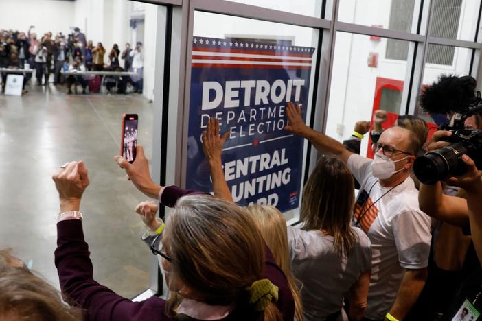 Supporters of President Trump bang on the glass and chant slogans outside the room where absentee ballots for the 2020 general election were counted at TCF Center on November 4, in Detroit, Mich.