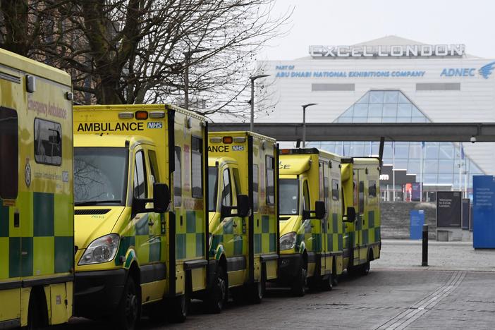 Ambulances are parked outside the NHS Nightingale hospital at the ExCeL center in east London on Friday. Hospitals in the U.K. are preparing for an influx of patients as the coronavirus continues to spread.