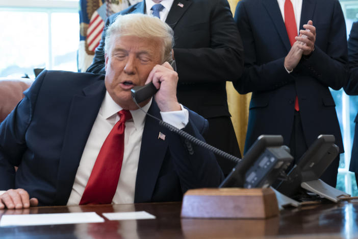 President Trump's phone call on Saturday with Georgia Secretary of State Brad Raffensperger spurred debates over whether the call broke the law. Here, Trump talks to the leaders of Israel and Sudan in October.