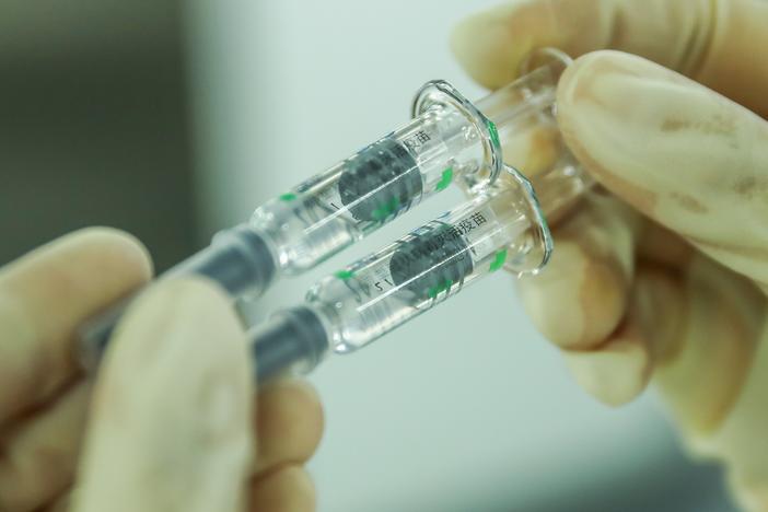 A staff member checks the packaging quality of COVID-19 inactivated vaccine products at a packaging plant of the Beijing Biological Products Institute Co. in Beijing last month.