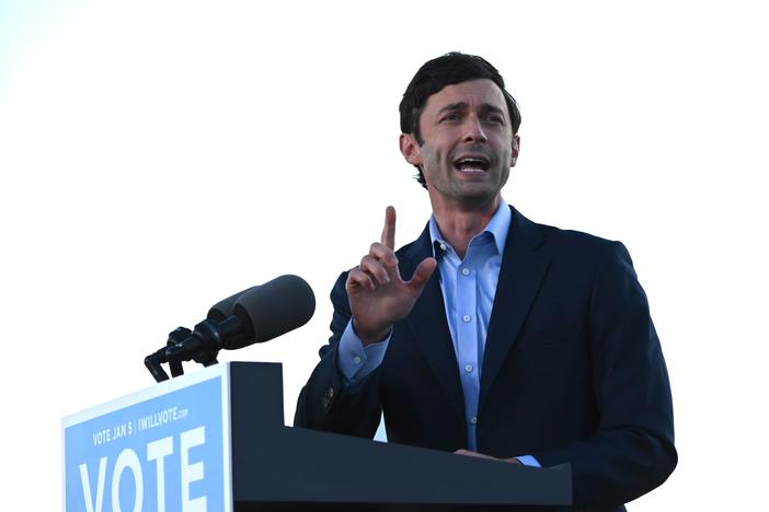 Democrat Jon Ossoff speaks at a rally outside of Center Parc Stadium in Atlanta on Monday.