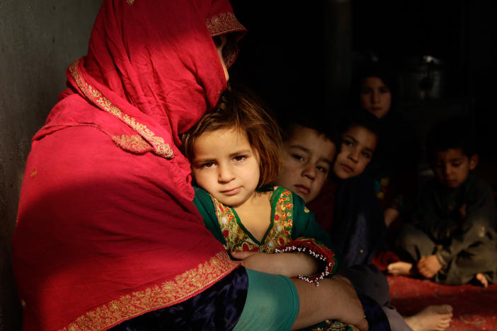 Shaista sits in her tiny home on the outskirts of Kabul. Her youngest, a 3-year-old girl, sits on her lap; some of her other seven children sit beside her. Behind them, she is boiling a pot of water on the wood-burning stove. But she's told the children it is dinner, and she tells them, "just wait for your father." Then she hopes they'll fall asleep, because there's no food to give them.