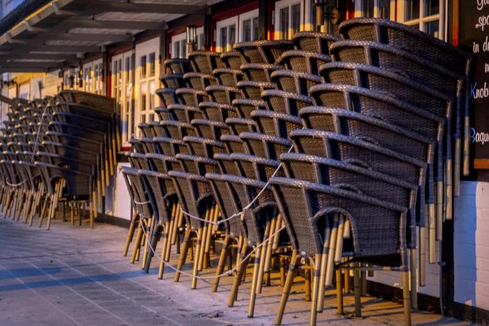 Chairs are piled up outside a restaurant Monday in the Baltic Sea resort town of Haffkrug, Germany.