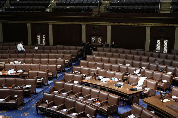 Papers and masks remain behind after House members left the floor of the House chamber as protesters tried to break into it at the U.S. Capitol on Wednesday.