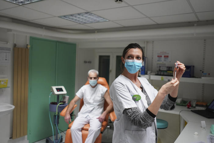 A nurse prepares to administer the Pfizer-BioNTech COVID-19 vaccine to Dr. Jean-Christophe Richard in La Croix-Rousse hospital, in Lyon, France, on Wednesday. Amid public outcry, France's health minister promised Tuesday an "exponential" acceleration of his country's slow coronavirus vaccination process.