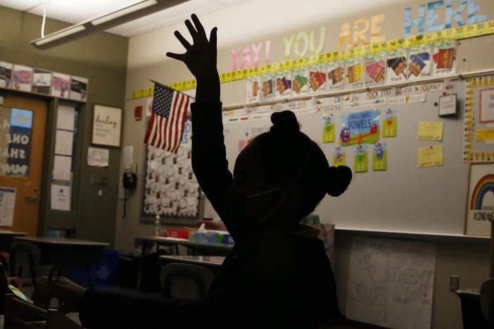 A first-grader raises her hand at Mary L. Fonseca Elementary School in Fall River, Mass., in November.