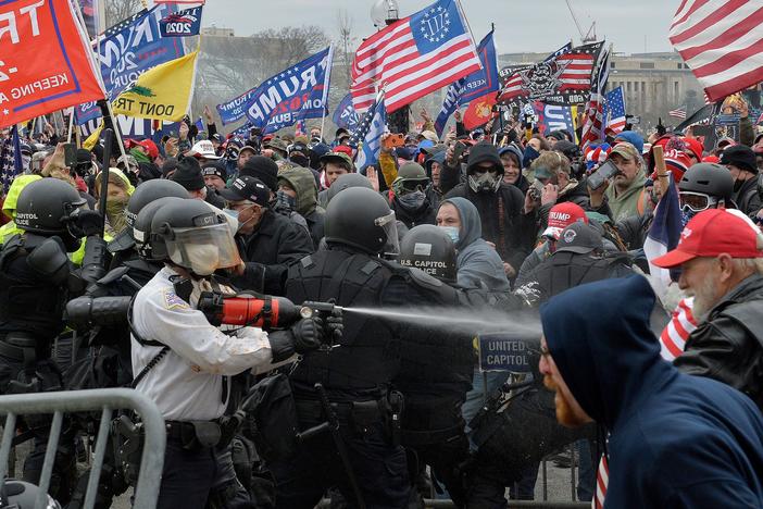 Trump supporters clash with police and security forces as they try to storm the Capitol in Washington, D.C. on Wednesday. Demonstrators breached security and entered the Capitol as Congress debated the 2020 electoral vote certification.