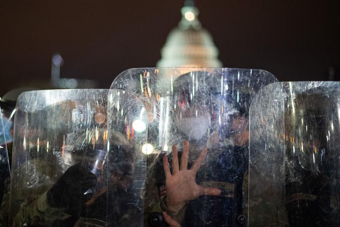 National Guard troops stand behind shields outside the Capitol building in Washington, D.C., on Wednesday evening.