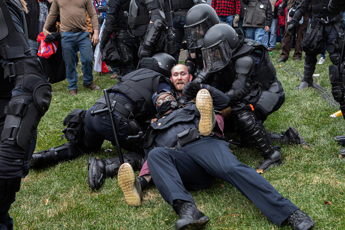 A pro-Trump protester resists arrest on Wednesday. There were few arrests in relation to the scope of the unrest as of Wednesday night.