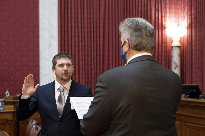 W. Va. Del. Derrick Evans, shown taking the oath of office in Charleston on Dec. 14, 2020 was seen in a video as part of the group of pro-Trump rioters who forced their way into the U.S. Capitol on Wednesday.