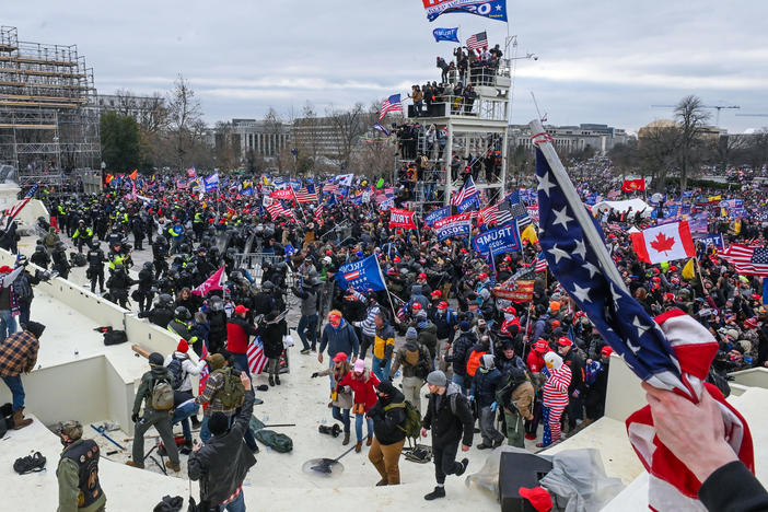 Pro-Trump extremists clash with police and security forces as they invade the Inauguration Day platform on Wednesday. Security forces were quickly overrun as the mob reached the Capitol.