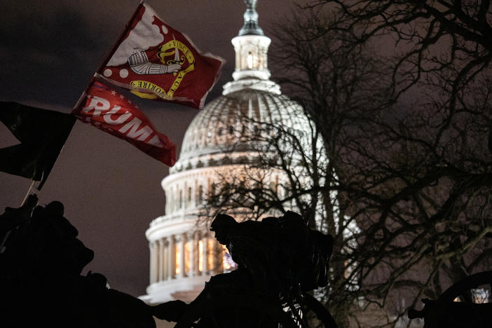 A Trump flag flies over the grounds of the U.S. Capitol on Wednesday after a mob stormed the building, breaking windows and clashing with police officers.