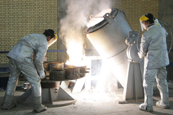 Technicians work inside of a uranium conversion facility producing unit in 2005 outside the city of Isfahan, Iran. After the 2015 Iran nuclear deal put limits on the program, Iran's government has been increasing uranium enrichment since the United States pulled out of deal.