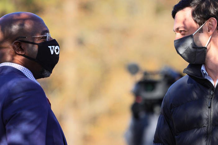 Georgia Sens.-elect Rev. Raphael Warnock (left) and Jon Ossoff before a campaign stop on Jan. 4. While the pair ran as a ticket, Warnock garnered nearly 20,000 more votes, in part due to many conservative voters' concerns about Warnock's GOP opponent, Sen. Kelly Loeffler.