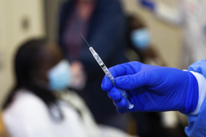 A doctor prepares to administer a vaccine injection at New York-Presbyterian Lawrence Hospital on Friday.