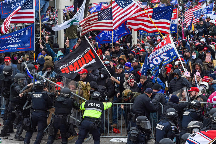 Police and security forces attempt to hold back a mob of pro-Trump extremists as they storm the U.S. Capitol in Washington on Wednesday.