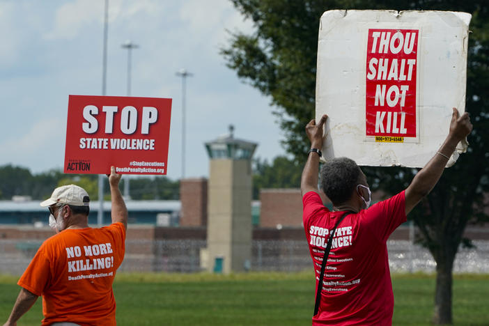 Protesters gather near the federal prison complex in Terre Haute, Ind., in August ahead of the scheduled execution of Keith Dwayne Nelson, who was convicted of kidnapping, raping and murdering at 10-year-old Kansas girl. Democrats are pushing new legislation to outlaw federal executions.