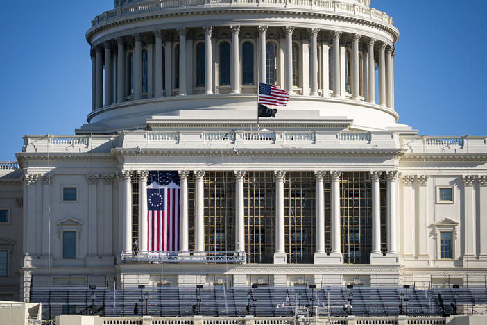 The American flag flies at half-staff on the west front of the U.S. Capitol after the Jan. 6 insurrection.