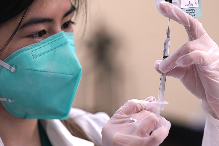 Skepticism about COVID-19 vaccinations has prompted suggestions that the government should pay people to get the shots. (AP Photo/LM Otero)