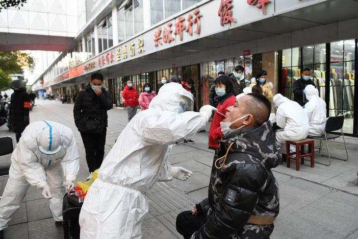 People queue up for nucleic acid testing at Hanzheng Street wholesale market on Tuesday, in Wuhan, Hubei Province of China.