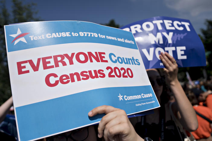 A demonstrator holds a sign about the U.S. census outside the Supreme Court in Washington, D.C., in 2019. The Census Bureau has stopped all work on President Trump's directive to produce a count of unauthorized immigrants that could be subtracted from a key set of census numbers, NPR has learned.