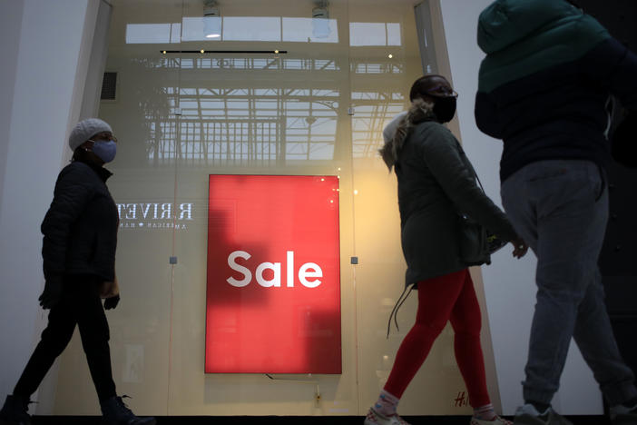 Shoppers walk past a "Sale" sign outside a store at the Easton Town Center Mall in Columbus, Ohio, on Jan. 7.