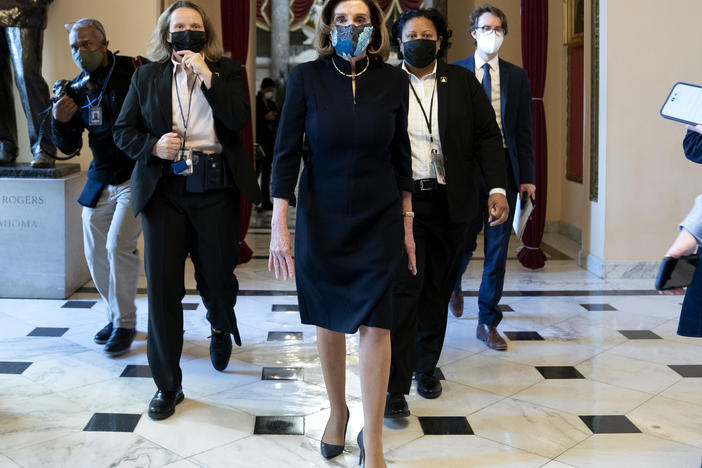 House Speaker Nancy Pelosi, D-Calif., said that impeaching President Trump is "a constitutional remedy that will ensure that the republic will be safe from this man." She's seen here walking to the House floor Wednesday ahead of the vote.