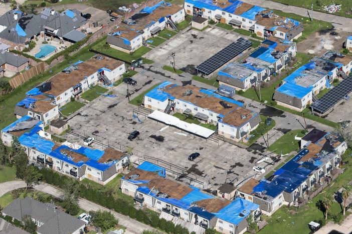 Blue tarps cover houses with damaged roofs in Lake Charles, La., after Hurricane Delta hit the city in October 2020.
