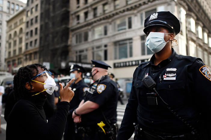 Shouting protesters face NYPD officers during a Black Lives Matter demonstration last summer in New York City, in outrage over the death of a Black man in Minnesota who died after a white policeman knelt on his neck for several minutes.