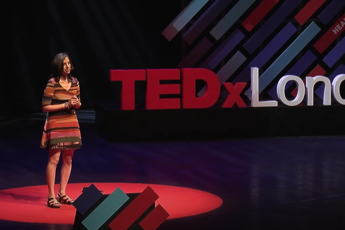 Beth Gardiner speaks on the TEDx stage in London.