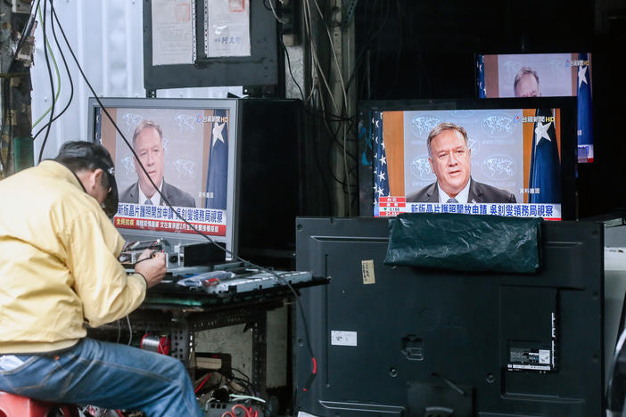 Televisions show a news broadcast of U.S. Secretary of State Mike Pompeo in Taipei, Taiwan, on Jan. 11. The Trump administration removed decades-old restrictions on interactions with Taiwanese officials just days before President-elect Joe Biden's inauguration.