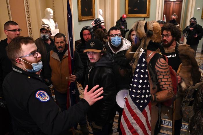 Jacob Chansley, the "QAnon Shaman" known for his painted face and horned hat, was taken into custody in Arizona in connection with the assault on the U.S. Capitol on Jan 6.