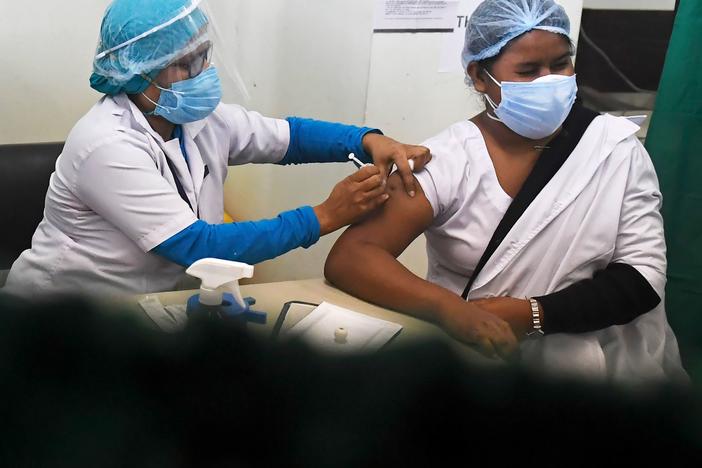 A medical worker inoculates a colleague with a COVID-19 vaccine at the Nil Ratan Sircar Medical College and Hospital in Kolkata on Saturday.