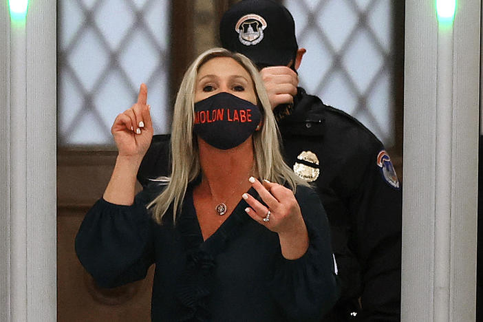 Rep. Marjorie Taylor Greene, R-Ga., yells at journalists after setting off the metal detector outside the doors to the House of Representatives Chamber on Jan. 12. Twitter suspended the newly elected lawmaker's account temporarily on Sunday.