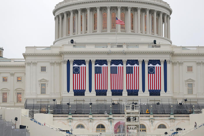 Wednesday's inauguration, coming two weeks to the day after the insurrection on the Capitol, will be unlike any other in living memory, writes NPR's Michel Martin. Above, the Capitol building is seen as workers prepare for the inauguration ceremony for Barack Obama in 2013.