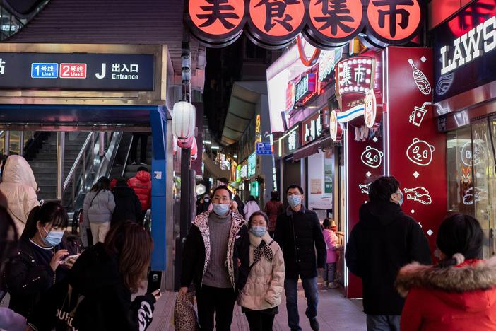 People walk in Wuhan on Jan. 10, the eve of the first anniversary of China confirming its first COVID-19 death. Chinese officials said on Monday that its economy managed to grow 2.3% in 2020.