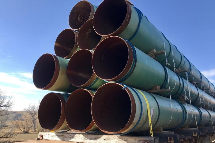 Keystone XL pipeline sections sit on a train near Glendive, Mont.