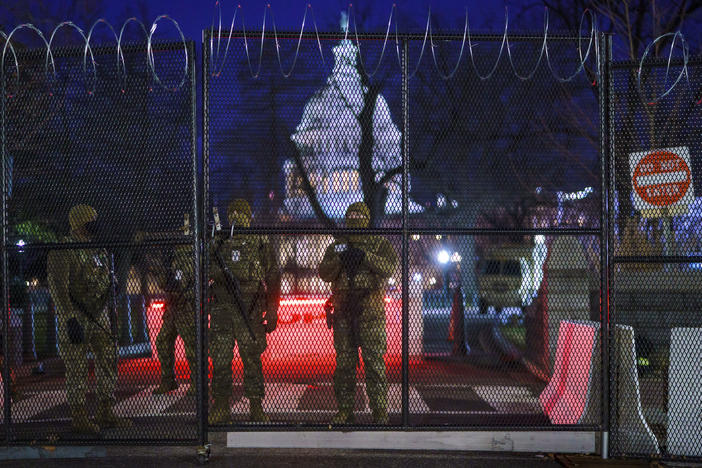 National Guard troops reinforce the security zone on Capitol Hill in Washington early Tuesday, before President-elect Joe Biden is sworn in as the 46th president on Wednesday.