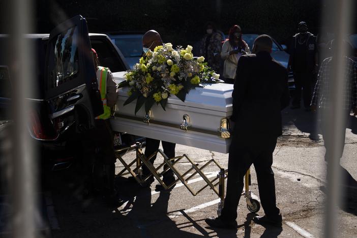 A casket is loaded into a hearse at the Boyd Funeral Home as burials at cemeteries are delayed to the surge of COVID-19 deaths on Jan. 14, 2021 in Los Angeles.