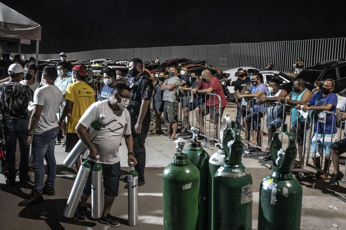 Workers check oxygen tanks at a hospital in Manaus, Brazil. Severe oxygen shortages as a second coronavirus wave is surging have prompted local authorities to airlift patients to other parts of Brazil.