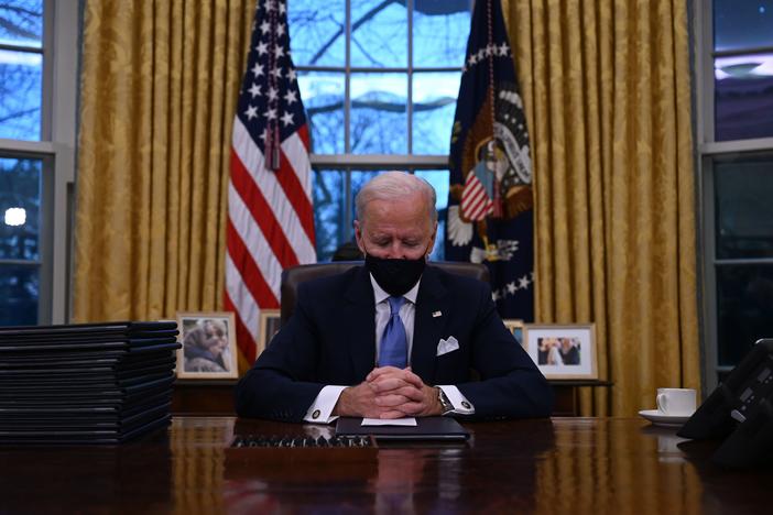 President Biden sits in the Oval Office at the White House after being sworn in as the 46th president of the United States on Wednesday.