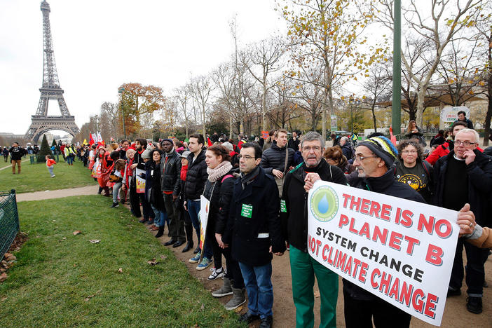 President Joe Biden is directing the U.S. to rejoin the international Paris Climate Agreement, which aims to cut global greenhouse gas emissions. Here, activists rally on Dec. 12, 2015.