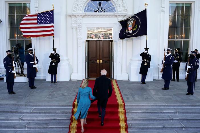 President Biden and first lady Jill Biden walk up the stairs as they arrive at the North Portico of the White House on Wednesday.