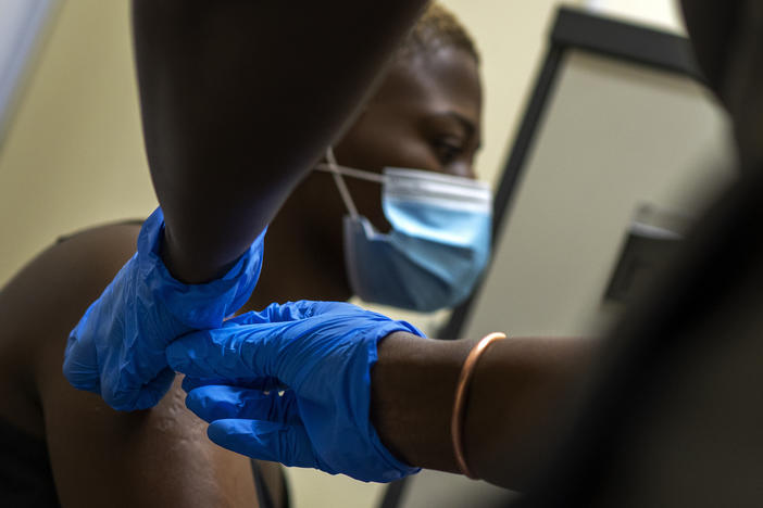 A volunteer receives a shot as part of a COVID-19 vaccine trial at Soweto's Chris Sani Baragwanath Hospital outside Johannesburg, South Africa, on Nov. 30, 2020.