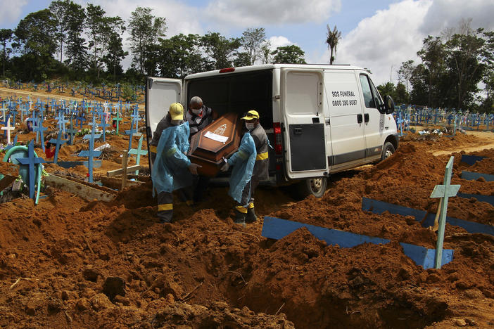 Cemetery workers carry the remains of 89-year-old Abilio Ribeiro, who died of the new coronavirus, for burial at the Nossa Senhora Aparecida cemetery in Manaus, Amazonas state, Brazil, on Jan. 6. The day before, Manaus declared a 180-day state of emergency due to a surge of new cases of the coronavirus.