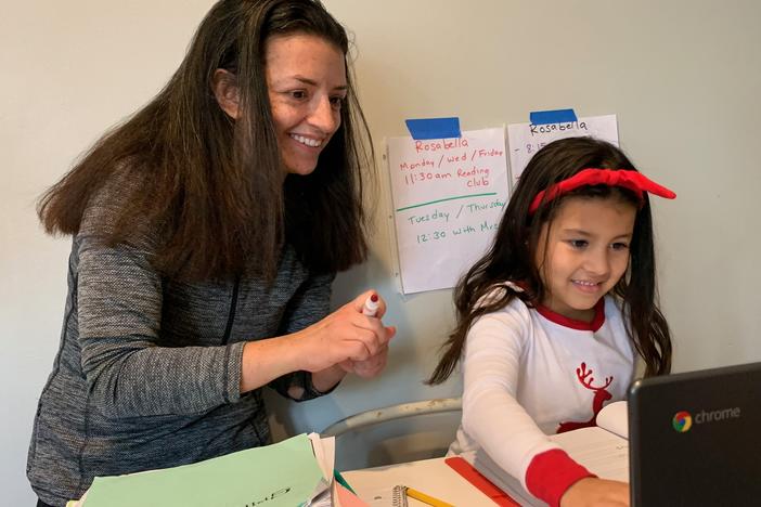 Chantelly Manzanares grades her daughter Rosabella's spelling test.  Because her mother is deaf, Rosabella sometimes uses American Sign Language to interpret what's happening in her classes on Zoom.