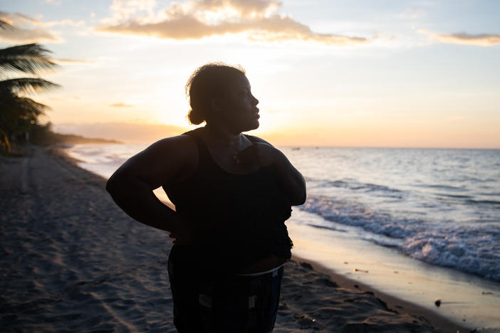 With the sun setting off the coast of northern Honduras, Ella Guity watches her daughters, Jirian and Eleny, swim in the warm Caribbean waters of the village of Rio Esteban, home to a group with African and indigenous roots known as the Garifuna. Ella had left years earlier for life in the big city, but the pandemic led her back home.