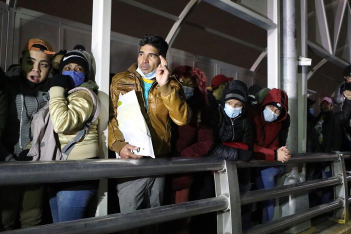 Cuban migrants block the Paso del Norte-Santa Fe international bridge between Mexico and the United States, to demand that the Trump administration allow them to wait for their asylum process on U.S. soil, in Ciudad Juarez, Mexico, on Dec. 29, 2020.